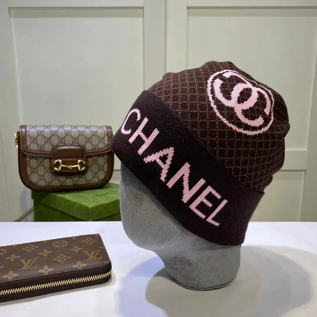 Dark beanie with pink Chanel lettering and a circular logo